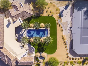 Aerial view of pool, lawn and tennis court