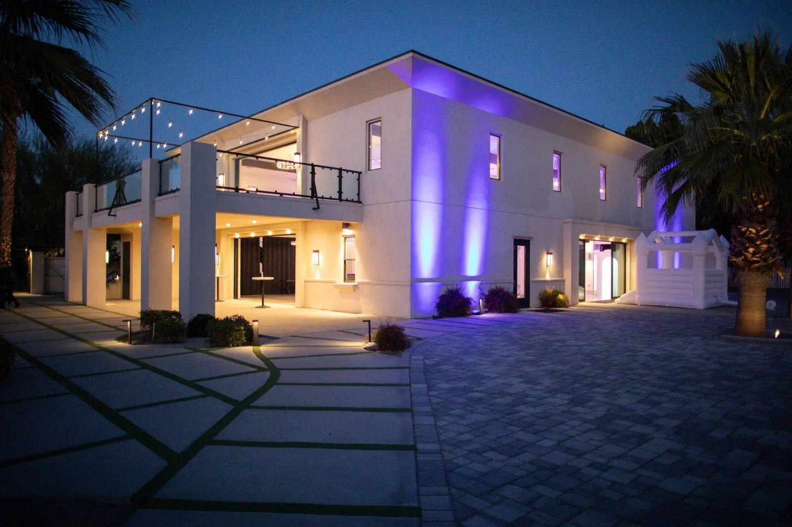 Estate exterior illuminated at dusk