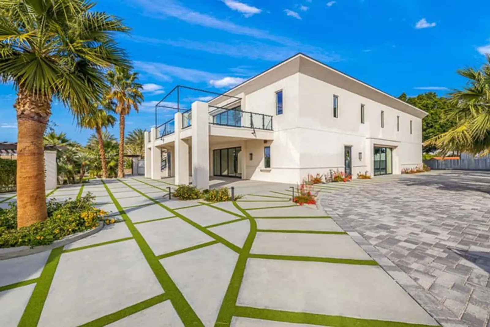 Venue exterior with palm-lined walkway